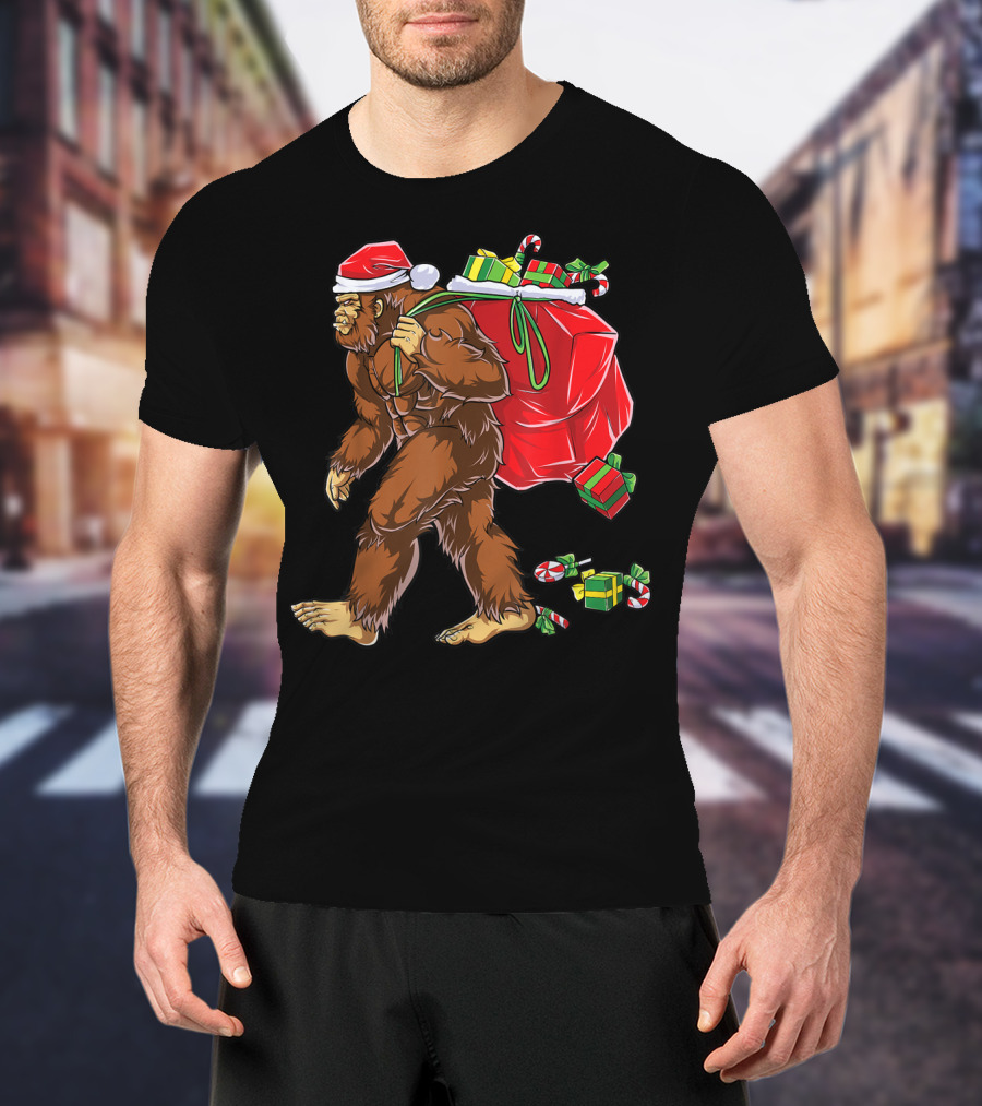 Bigfoot Santa With Giant Red Christmas Bag And Green Gifts Wearing Xmas Hat T-Shirt