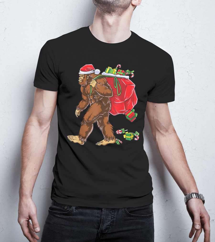 Bigfoot Santa With Giant Red Christmas Bag And Green Gifts Wearing Xmas Hat T-Shirt