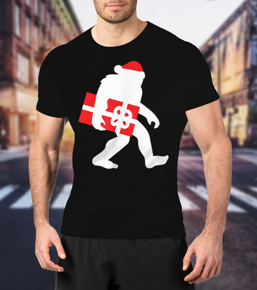 Nice Bigfoot Carrying Christmas Gift In Santa Hat T-Shirt