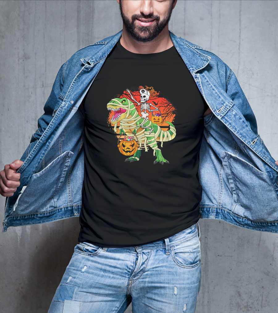 Skeleton Riding Mummy Dinosaur Rex With Halloween Pumpkins On Spooky Background T-Shirt