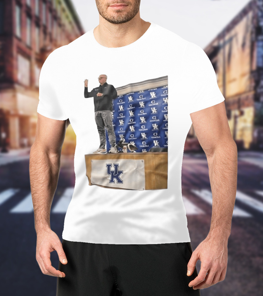 UK Volleyball Coach Craig Skinner Standing On Table With UK Logo And Awards T-Shirt