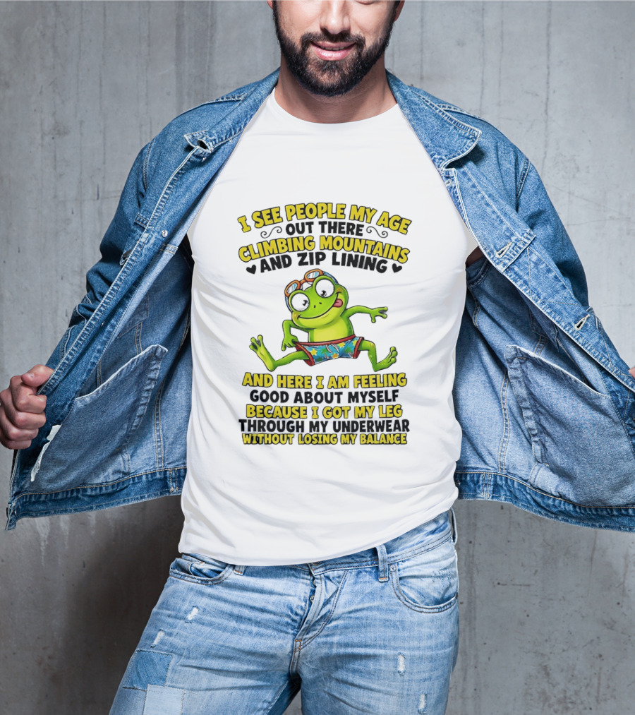 I See People My Age Climbing Mountains And Zip Lining Cartoon Frog Feeling Good Without Losing Balance T-Shirt