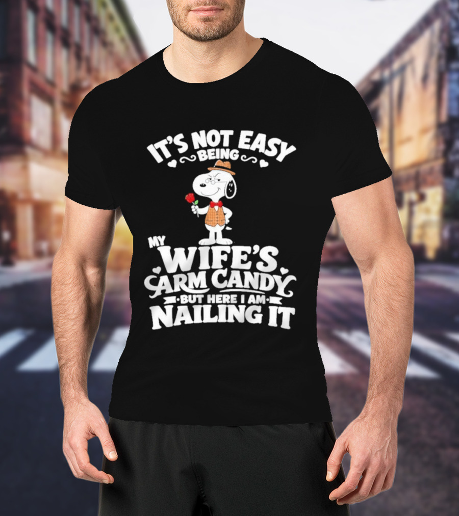 Snoopy It's Not Easy Being My Wife's Arm Candy But Here I Am Nailing It T-Shirt
