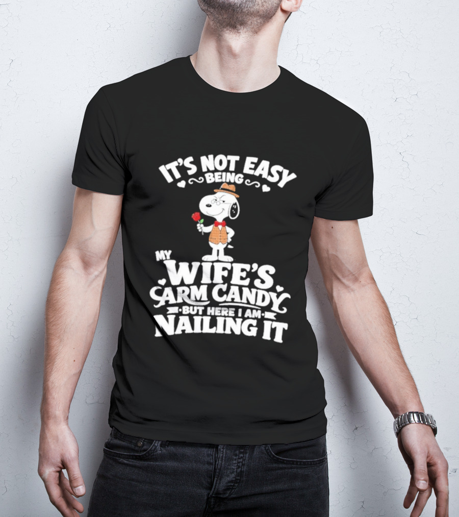 Snoopy It's Not Easy Being My Wife's Arm Candy But Here I Am Nailing It T-Shirt
