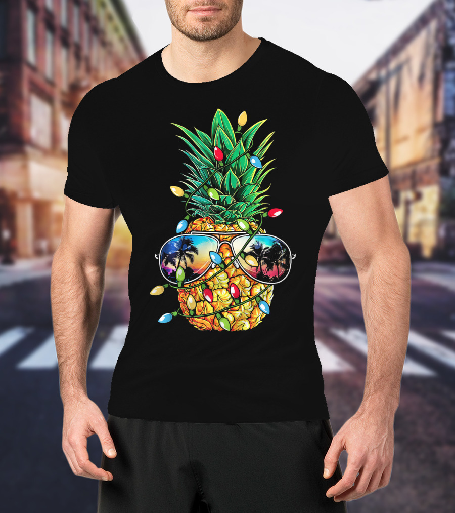 Pineapple Wrapped In Christmas Lights With Sunglasses Reflected Sunset And Palm Trees T-Shirt