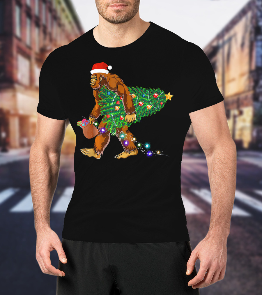 Santa Hat Bigfoot Holding Christmas Tree With Lights And Gifts T-Shirt