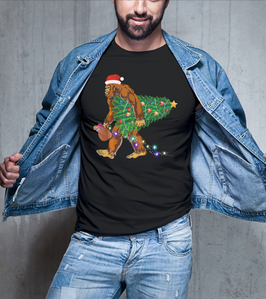 Santa Hat Bigfoot Holding Christmas Tree With Lights And Gifts T-Shirt